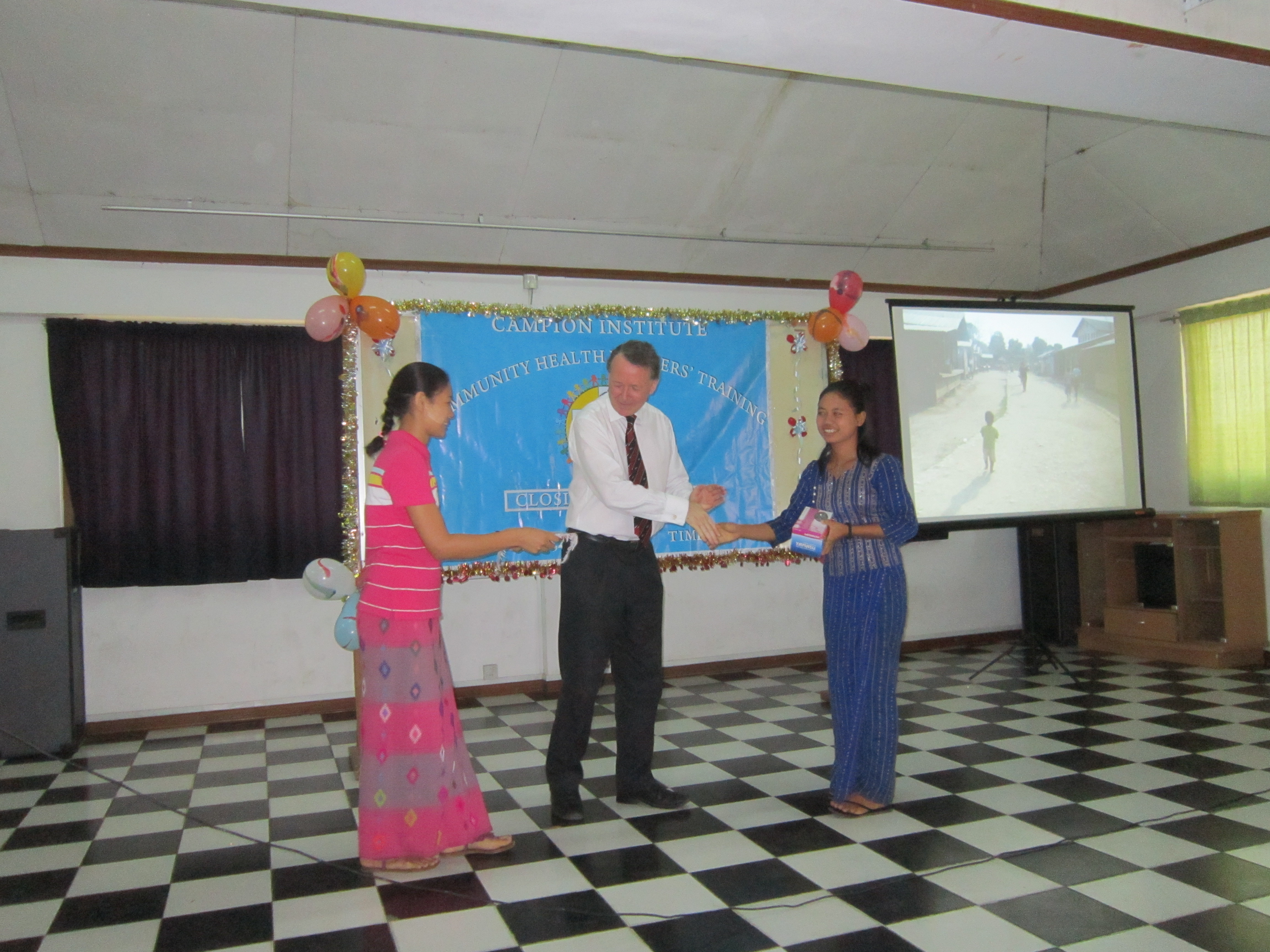 Presenting community health awards at the Campion Institute, Rangoon