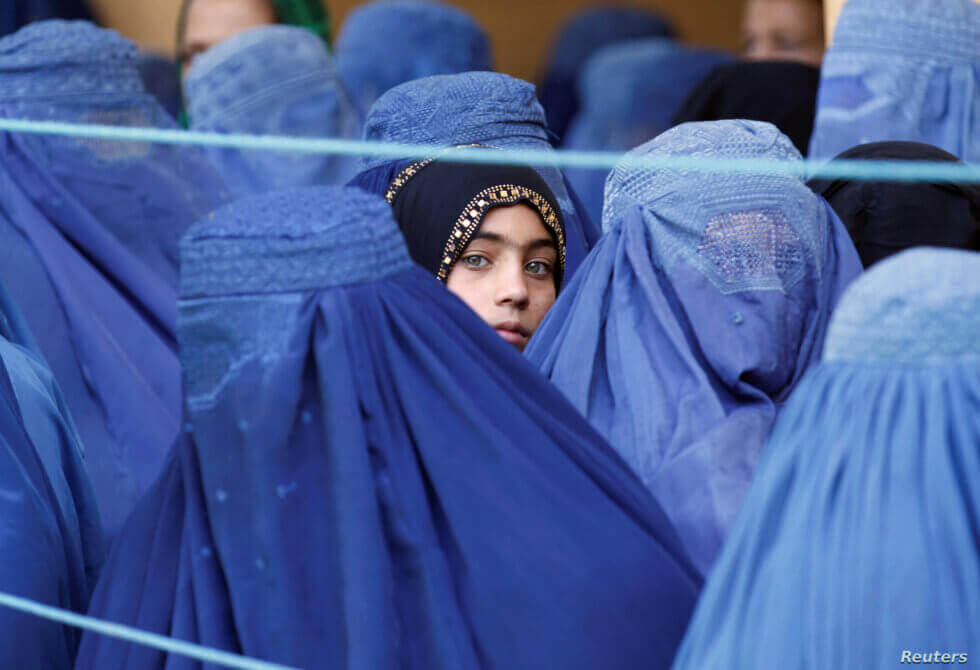 a girl looks on among Afghan women